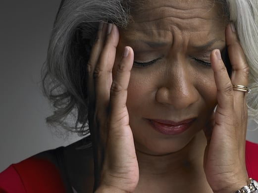 woman holding her head 
