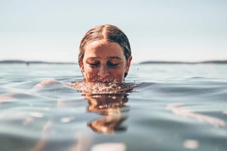 Woman with her head halfway in the water